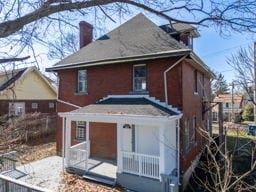 rear view of house featuring a chimney