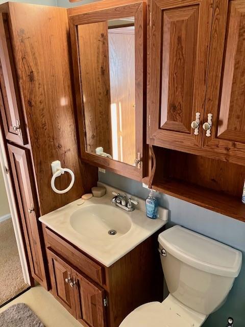 bathroom featuring toilet and vanity