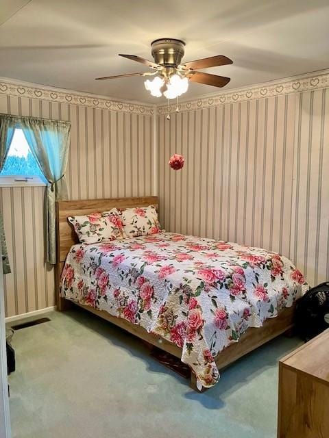 bedroom with carpet flooring, wallpapered walls, and ceiling fan