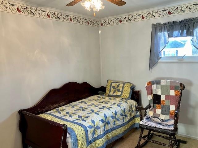 carpeted bedroom with a ceiling fan