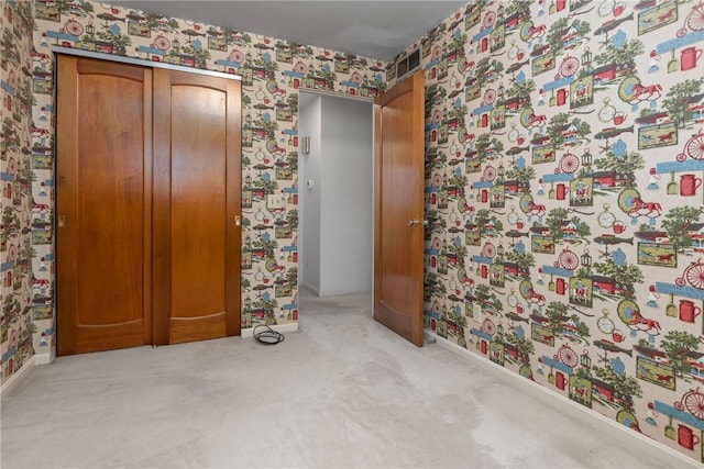 unfurnished bedroom featuring wallpapered walls, baseboards, and carpet floors