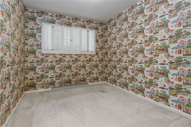 unfurnished room featuring wallpapered walls, carpet, and baseboards