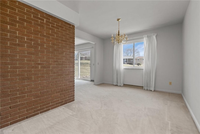 unfurnished room with baseboards, light carpet, a chandelier, and brick wall