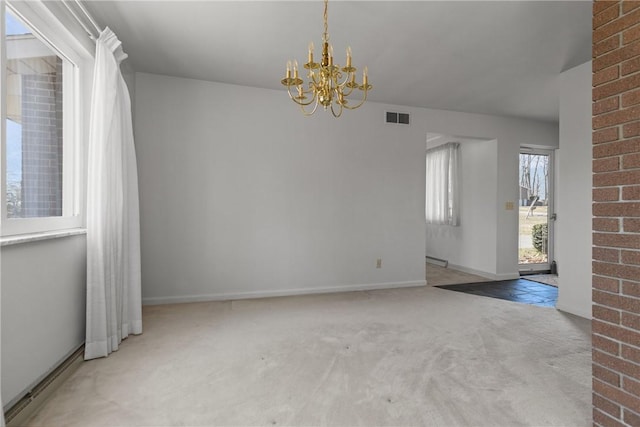 carpeted spare room featuring an inviting chandelier, baseboards, and visible vents