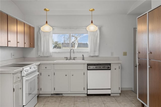 kitchen with white appliances, light tile patterned floors, a sink, light countertops, and pendant lighting