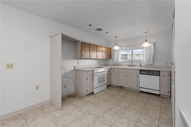 kitchen featuring visible vents, pendant lighting, light countertops, white appliances, and a sink