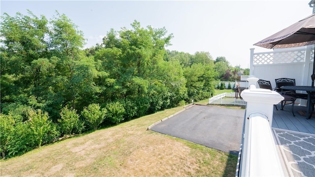 view of yard featuring driveway and fence