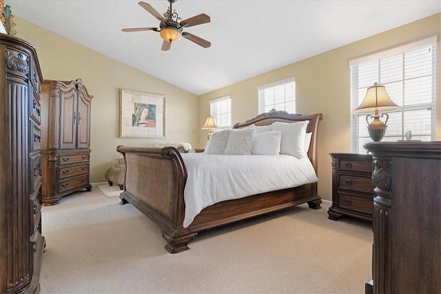 bedroom featuring a ceiling fan, lofted ceiling, and light colored carpet