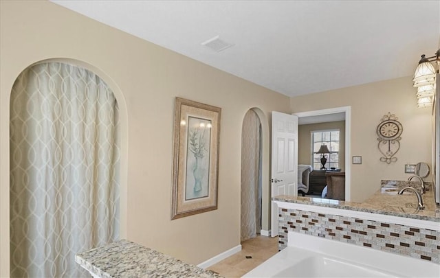 8004 Maureen Dr, Cranberry Twp, PA 16066 - ensuite bathroom with baseboards, tile patterned flooring, and a bath