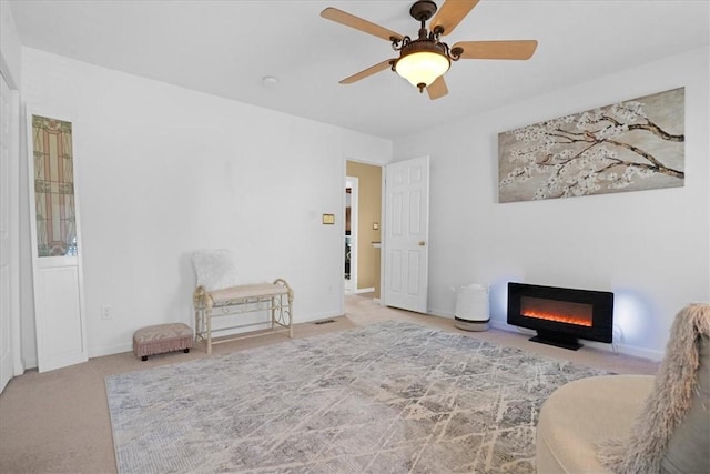 8004 Maureen Dr, Cranberry Twp, PA 16066 - living area featuring a glass covered fireplace, carpet flooring, a ceiling fan, and baseboards