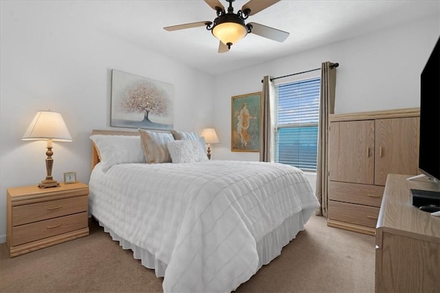 bedroom featuring a ceiling fan and light colored carpet