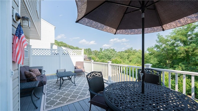 wooden terrace featuring outdoor dining area