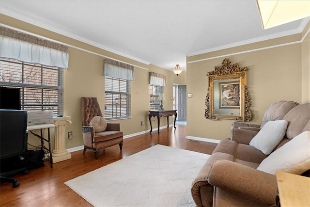 living area featuring crown molding, wood finished floors, and baseboards