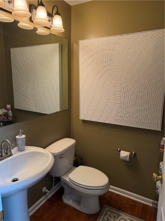 8004 Maureen Dr, Cranberry Twp, PA 16066 - bathroom with wood finished floors, toilet, and baseboards