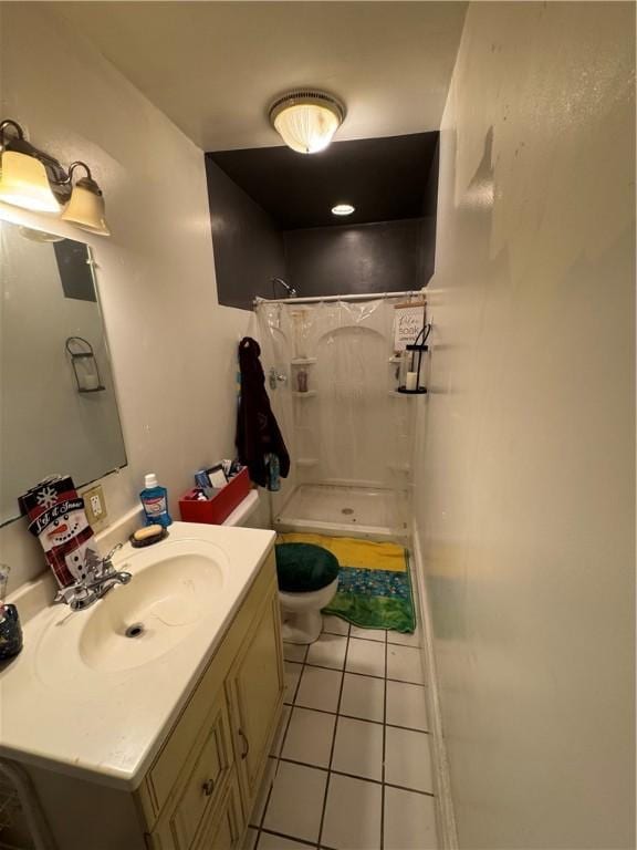 bathroom with tile patterned floors, a shower stall, vanity, and toilet