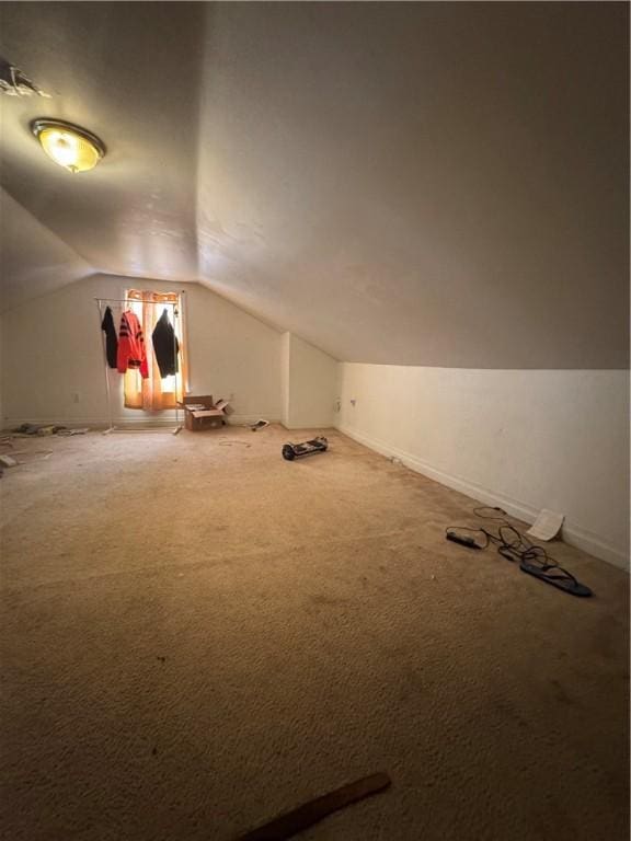 bonus room featuring baseboards, lofted ceiling, and carpet floors