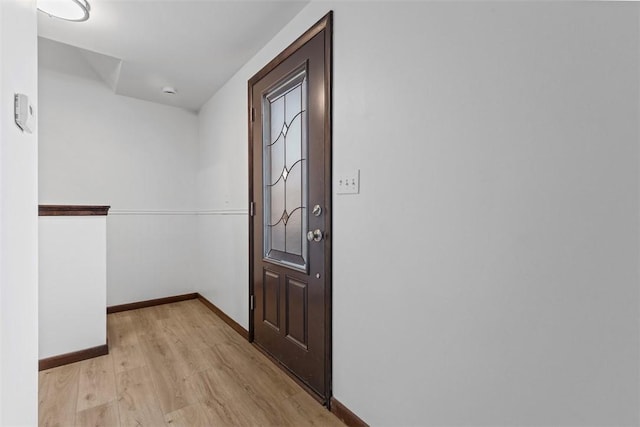 interior space featuring baseboards and light wood-style floors