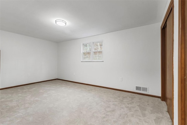 unfurnished bedroom featuring a closet, baseboards, visible vents, and carpet floors