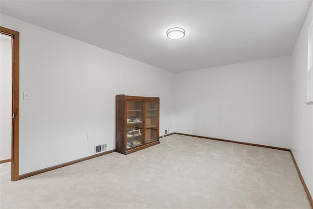 carpeted empty room with baseboards and visible vents