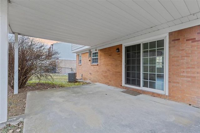 view of patio featuring cooling unit, an attached carport, and fence