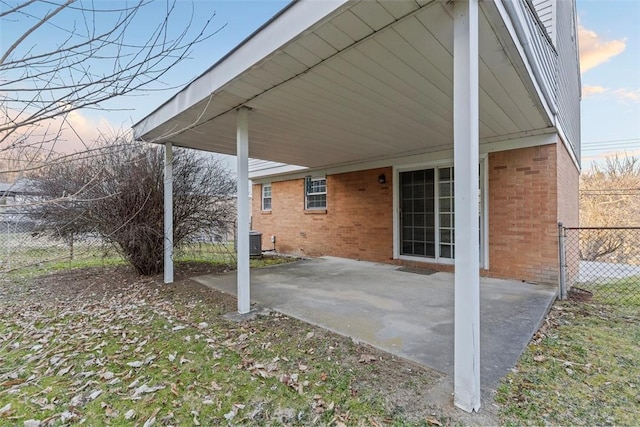 view of patio featuring a carport, central AC, and fence