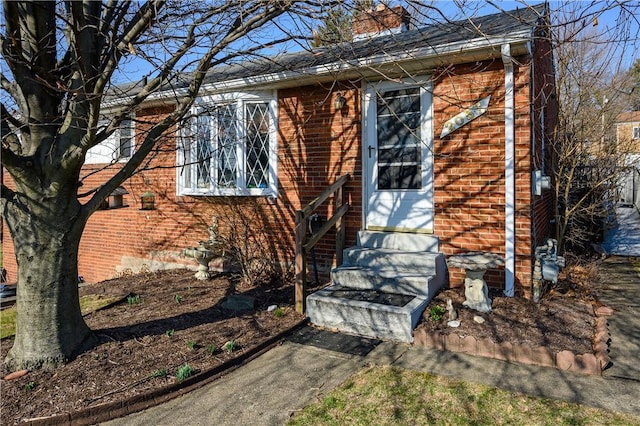 property entrance featuring brick siding