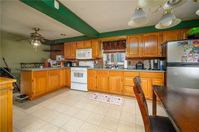 kitchen with beamed ceiling, a sink, white appliances, a peninsula, and ceiling fan