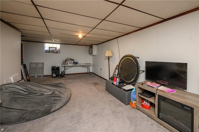 below grade area with carpet flooring, a paneled ceiling, and baseboards