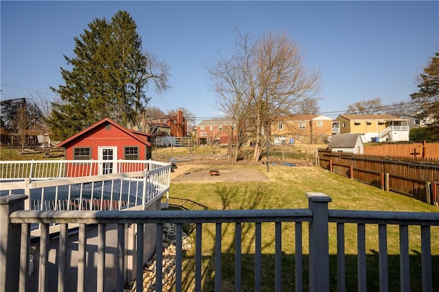 view of yard with a residential view, fence private yard, and a deck