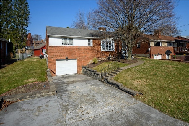 single story home with brick siding, an attached garage, concrete driveway, and a front lawn