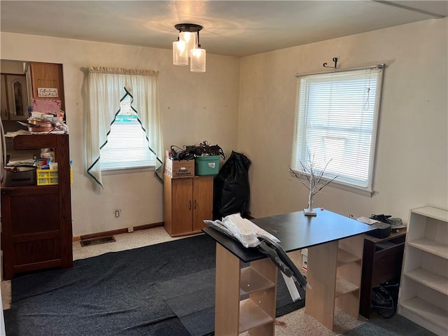 carpeted home office with visible vents, plenty of natural light, and baseboards