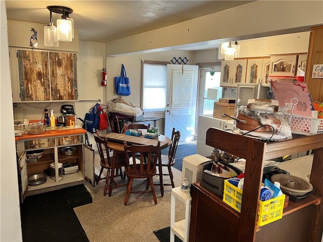 dining space featuring carpet flooring and washer / clothes dryer