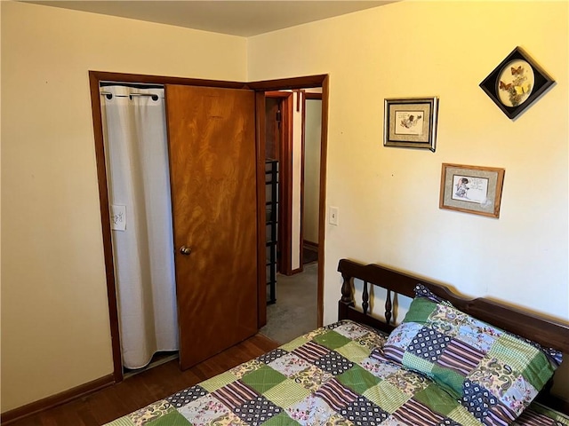 bedroom with baseboards and dark wood-style flooring