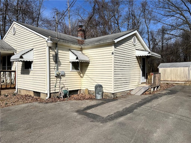 4 Woodbine Dr, Hempfield Twp Mer, PA 16125 - view of side of property featuring a chimney and an outbuilding