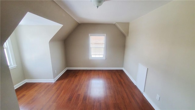 additional living space featuring lofted ceiling, baseboards, and wood finished floors