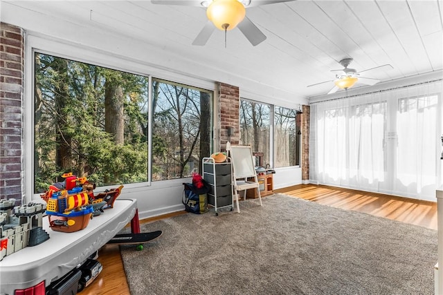 sunroom with a healthy amount of sunlight and ceiling fan