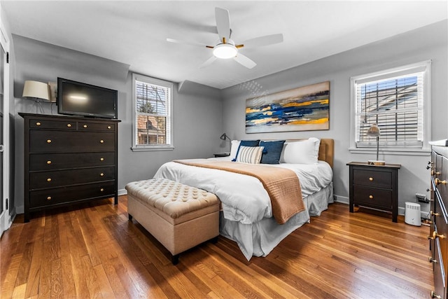 bedroom featuring ceiling fan, baseboards, and hardwood / wood-style floors