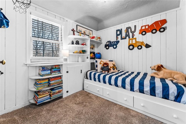 bedroom with a textured ceiling and carpet