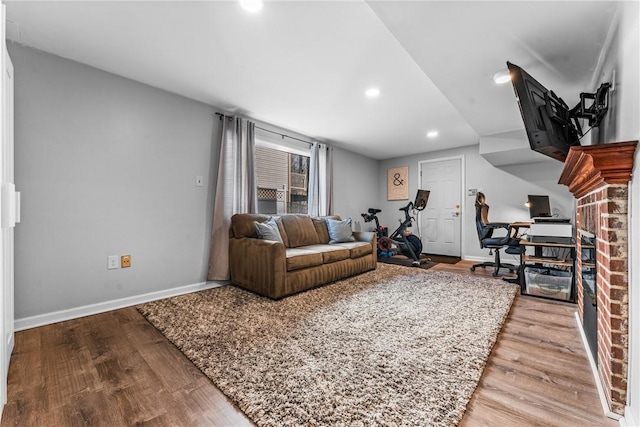 living room with recessed lighting, baseboards, and wood finished floors