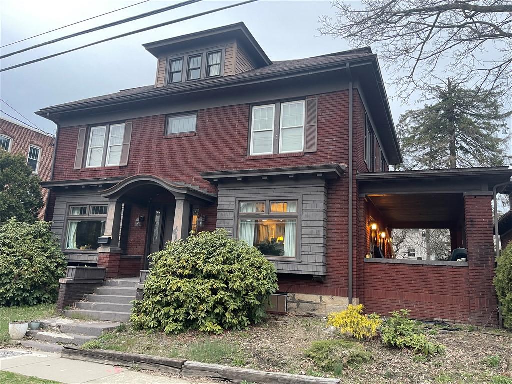 traditional style home featuring brick siding