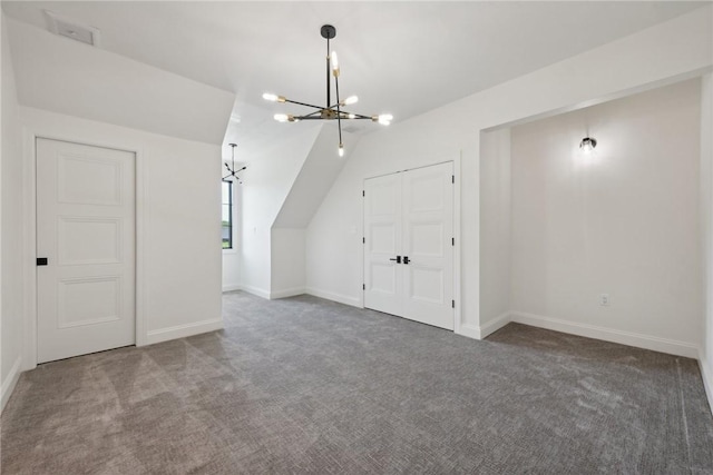 bonus room featuring an inviting chandelier, carpet flooring, and baseboards