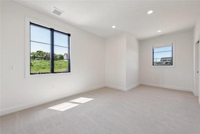 unfurnished room featuring recessed lighting, baseboards, and light carpet