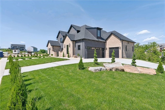 view of front facade featuring a front lawn, a garage, and driveway