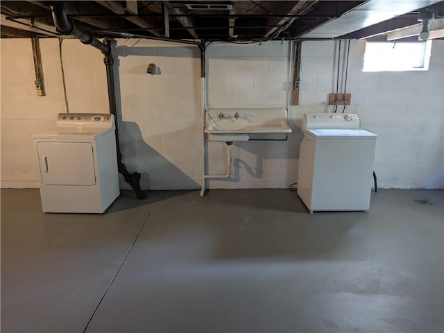 below grade area with washing machine and dryer and a sink