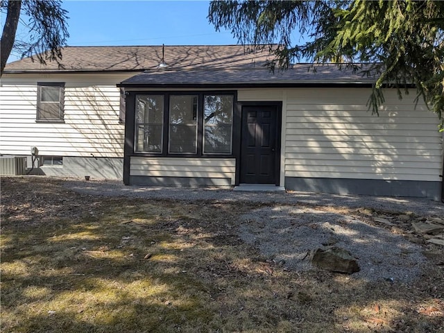 exterior space featuring a shingled roof