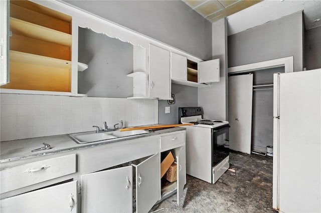 kitchen with white appliances, open shelves, a sink, light countertops, and white cabinets