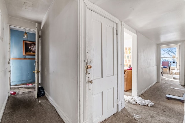 carpeted foyer with baseboards