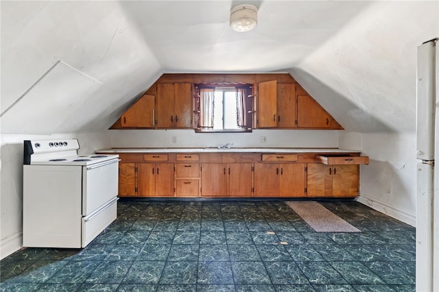 kitchen with brown cabinets, white appliances, light countertops, and lofted ceiling