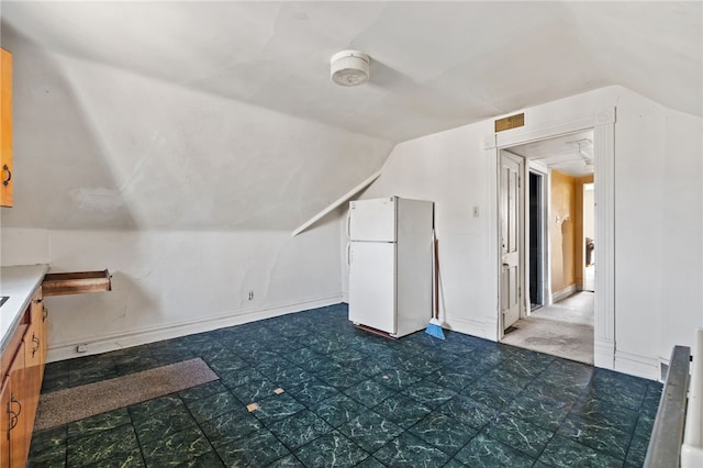 bonus room featuring tile patterned floors and vaulted ceiling