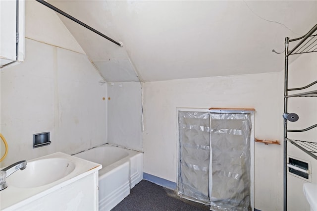 bathroom featuring lofted ceiling and vanity